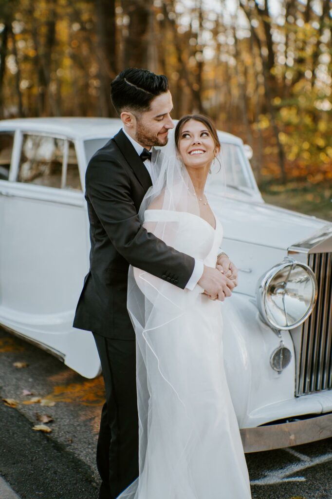 Bride and Groom Smile with Vintage Rolls Royce at Saphire Estate in Sharon Massachusetts