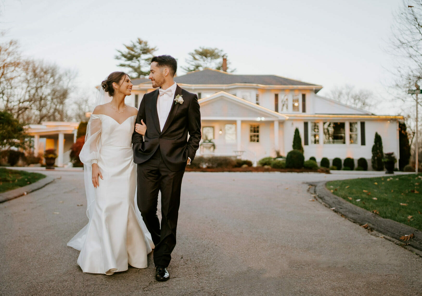 Bride and Groom Walk in Front of Saphire Estate in Sharon Massachusetts