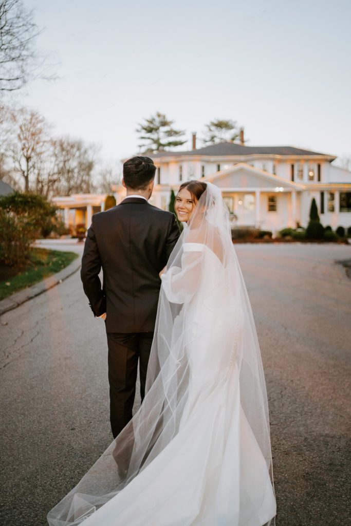 Bride and Groom Walk Towards Saphire Estate in Sharon Massachusetts