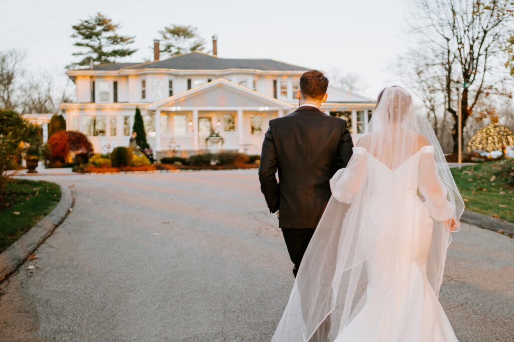 Bride and Groom Walk Towards Saphire Estate in Sharon Massachusetts