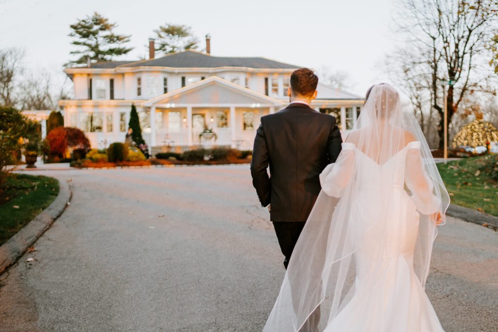 Bride and Groom Walk Towards Saphire Estate in Sharon Massachusetts