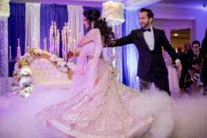 Indian Bride and Groom Dance at Wedding Reception with Purple Color Scheme