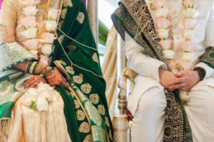 Indian Bride and Groom in Traditional Wedding Attire in Gold and Green
