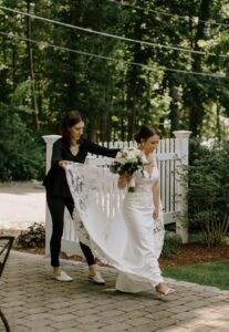 Wedding Producer at Saphire Estate Helps Bride with Dress Before Her Massachusetts Summer Wedding Ceremony