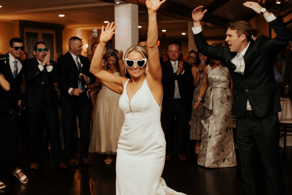 Bride Dances in White Heart Sunglasses at Her Massachusetts Wedding
