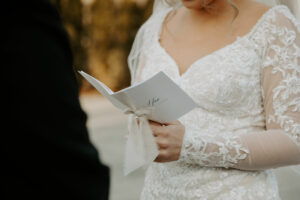 Bride Holds White Vow Book and Recites Vows to Groom at The Villa