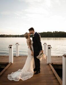 Bride and Groom Kiss on Dock at Massachusetts Waterfront Wedding Venue The Lakehouse