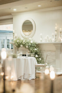 Sweetheart Table Decorated With Floating Candles and Babys Breath