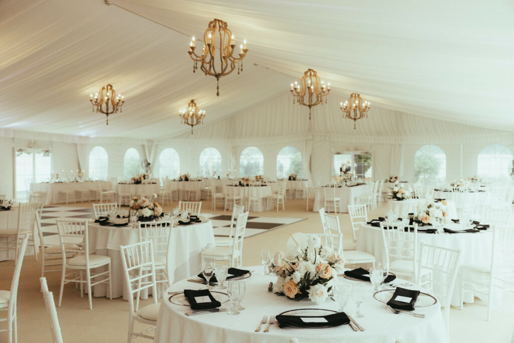 Reception Set Up Romantic Tables and Chandeliers In Tent