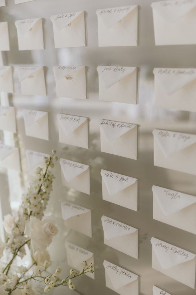 White and Silver Seating Chart Display With White Florals