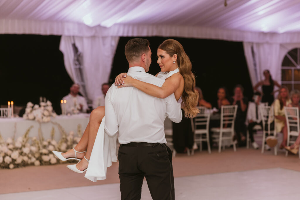 Groom Carries Bride Across Dance Floor