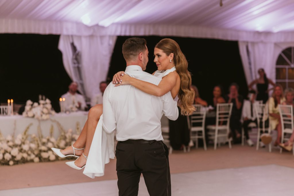 Groom Carries Bride Across Dance Floor