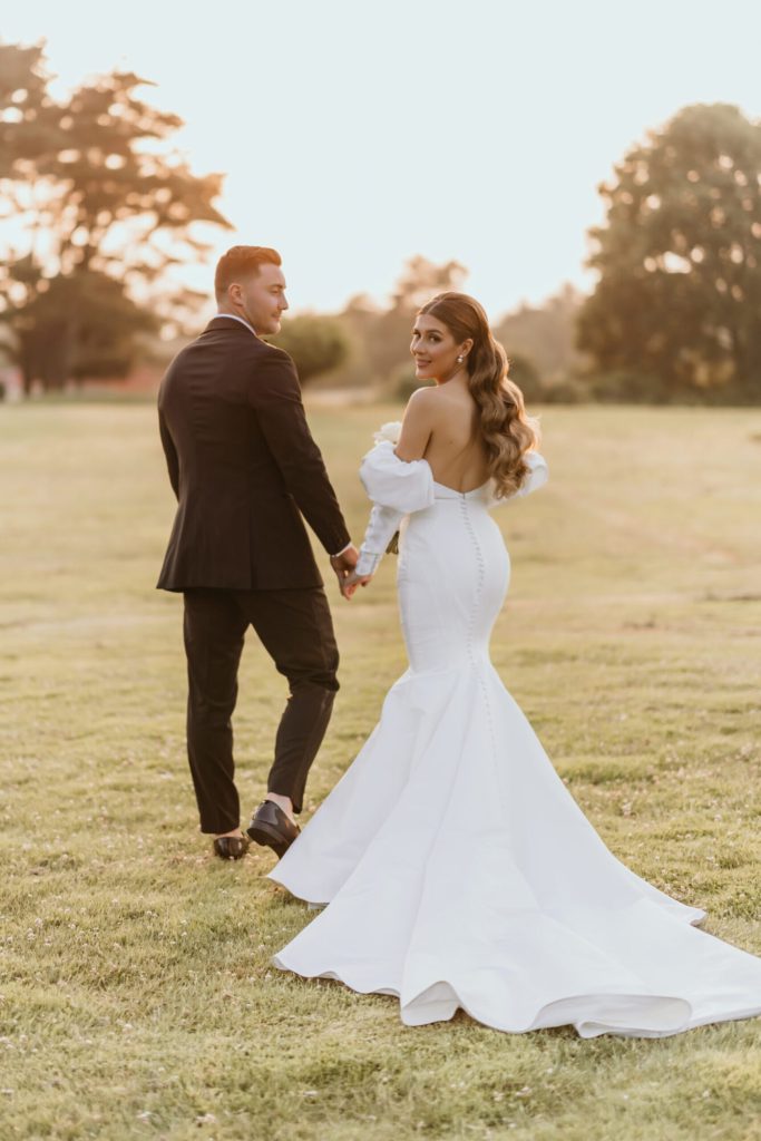 Bride and Groom Golden Hour Portrait Looking Over Shoulders