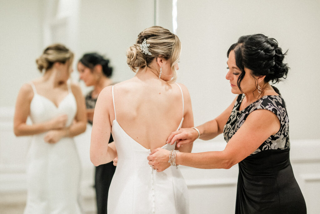Bride and Mother Getting Ready In Wedding Suite