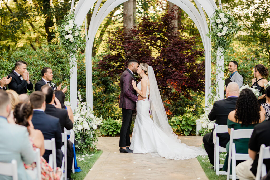 First Kiss As Husband and Wife Under Florals