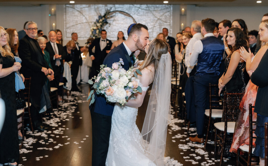 The Villa Grand Ballroom Indoor Ceremony Bride and Groom Kiss