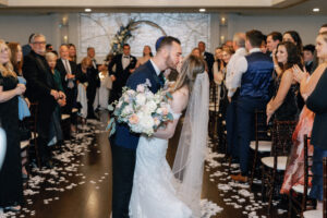 The Villa Grand Ballroom Indoor Ceremony Bride and Groom Kiss
