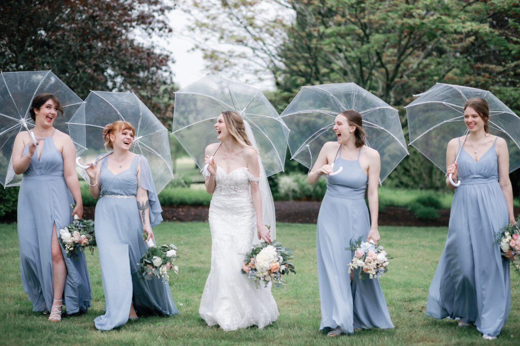 Bride and Bridesmaids With Umbrellas and Dusty Blue Dresses