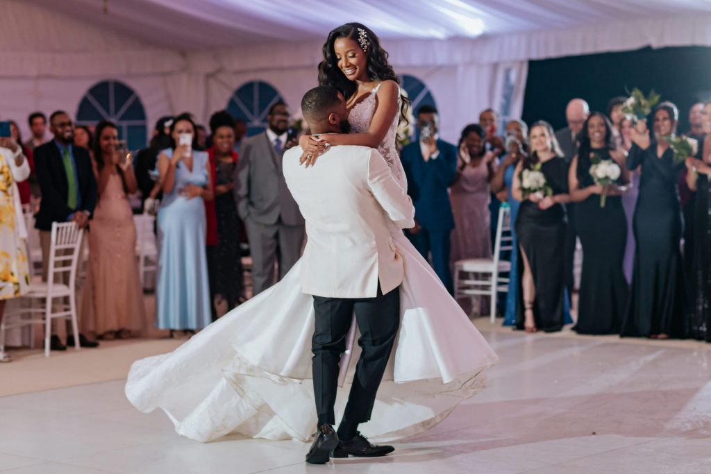 Groom Twirling Bride During First Dance