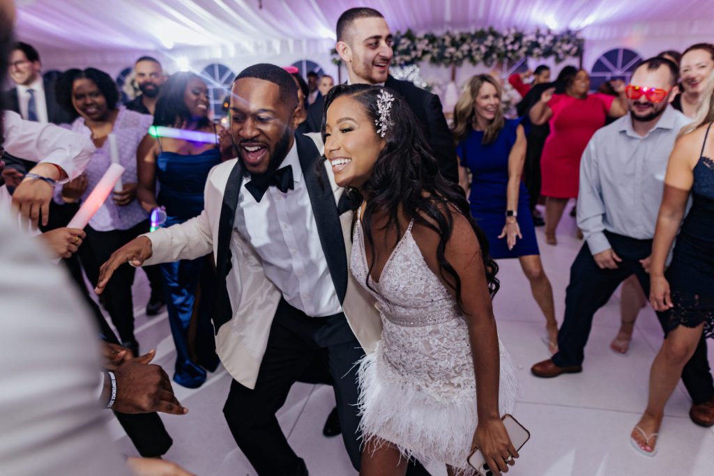 Bride and Groom Dancing With Guests During Reception