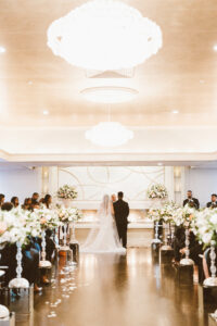 Bride and Groom From Behind During Indoor Grand Ballroom Ceremony 