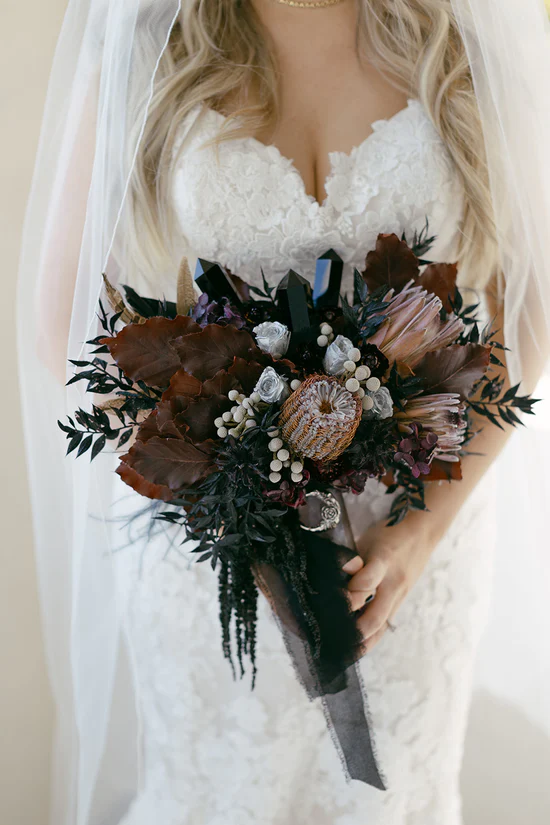 Dark and moody wedding bouquet with dark crystals