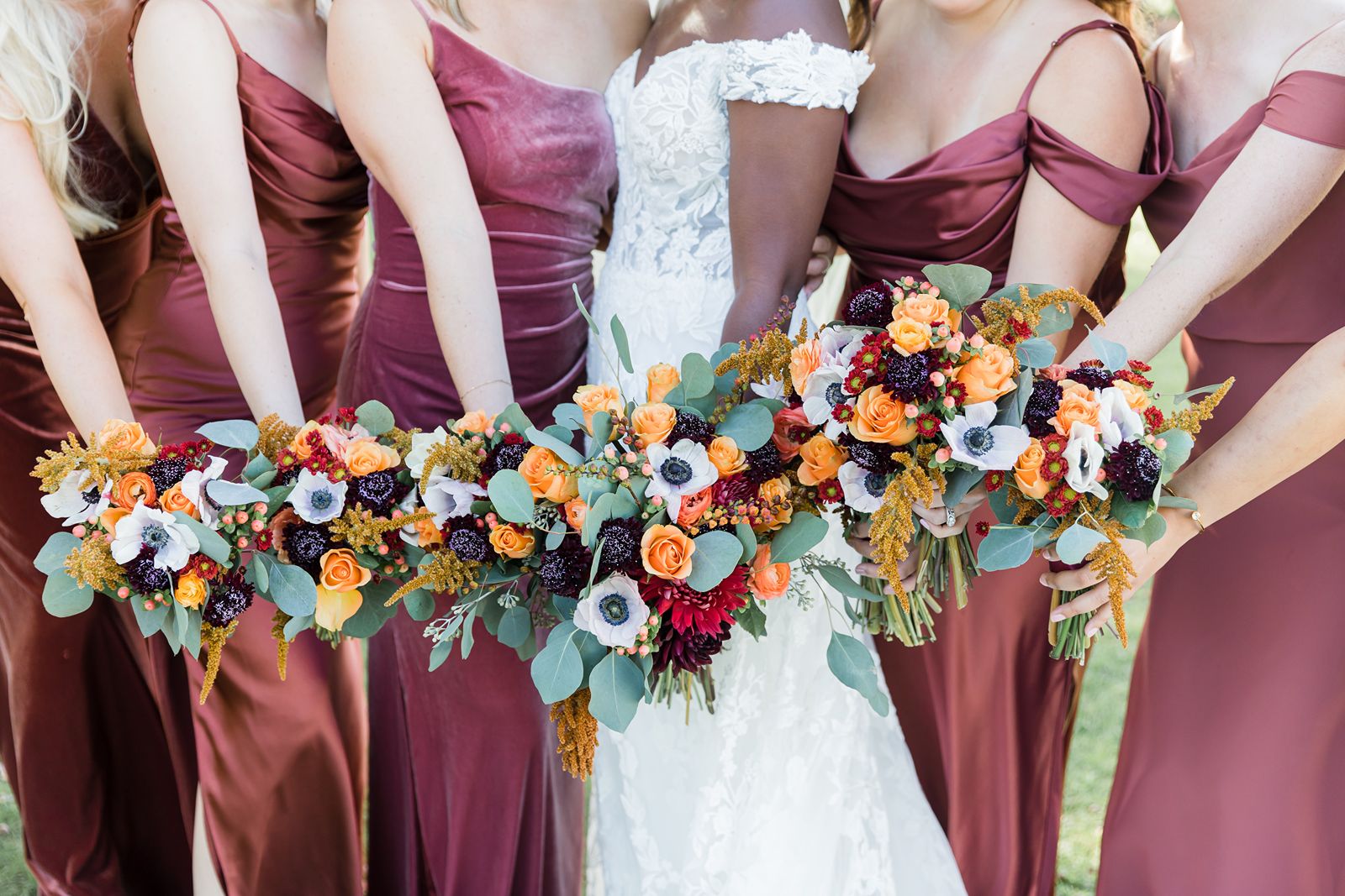 Bride and bridesmaids holding beautiful wedding flowers