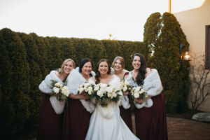 Bride and Bridesmaids in Fur Shawls at a winter wedding