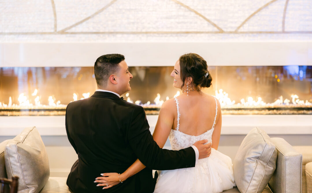 Bride and Groom Embracing by Warm Fireplace