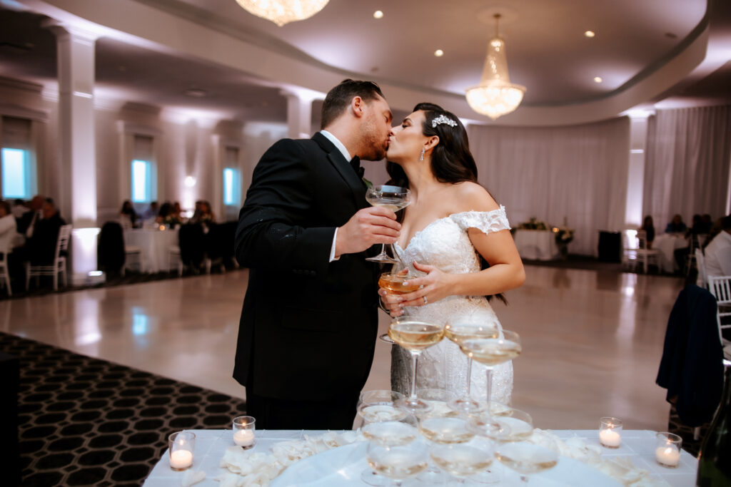 Bride and Groom Kissing Over Champagne Tower