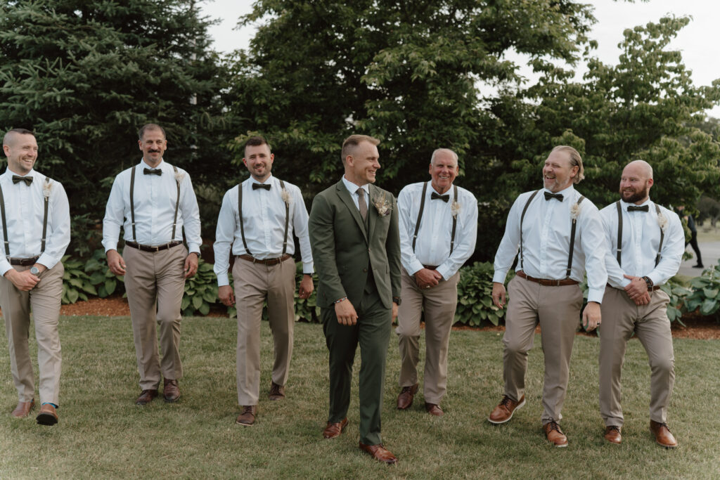 groomsmen and groom in suspenders