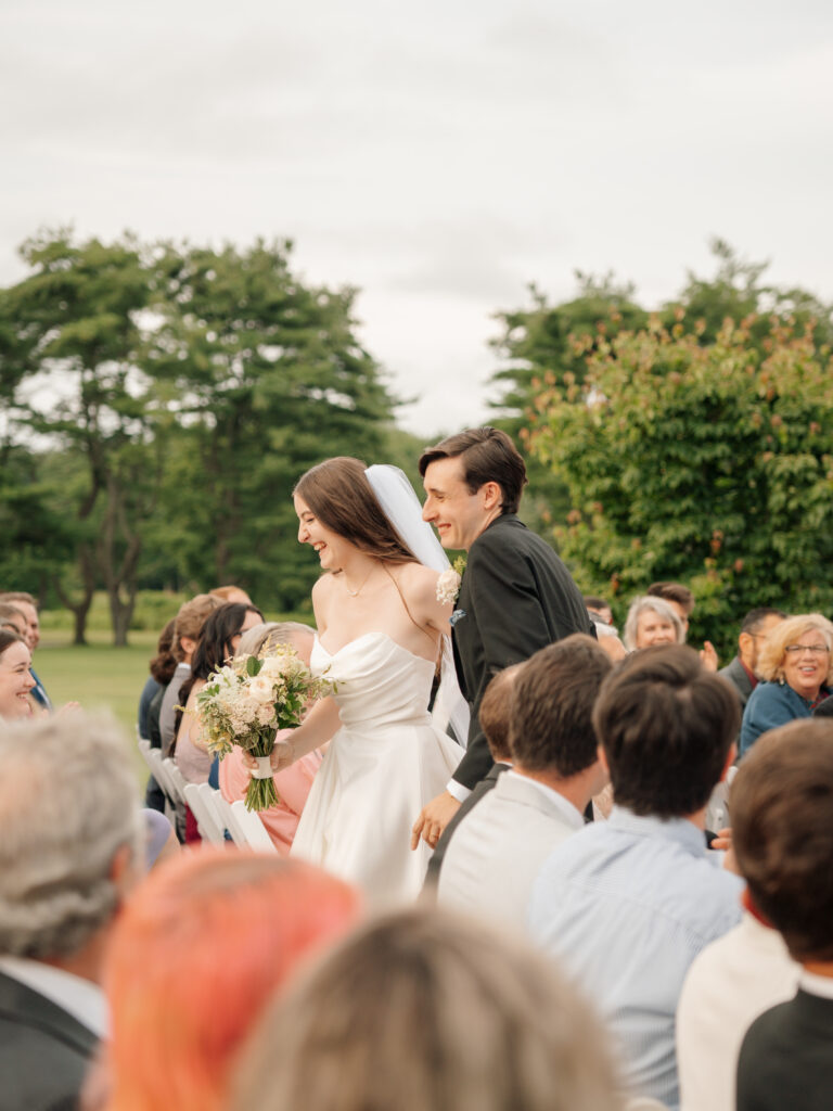 Bride and Groom Laughing During Recessional