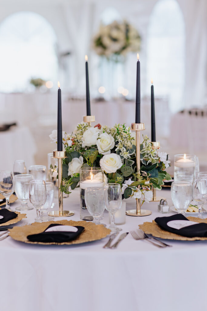 Black candles and gold chargers wedding trend table decor