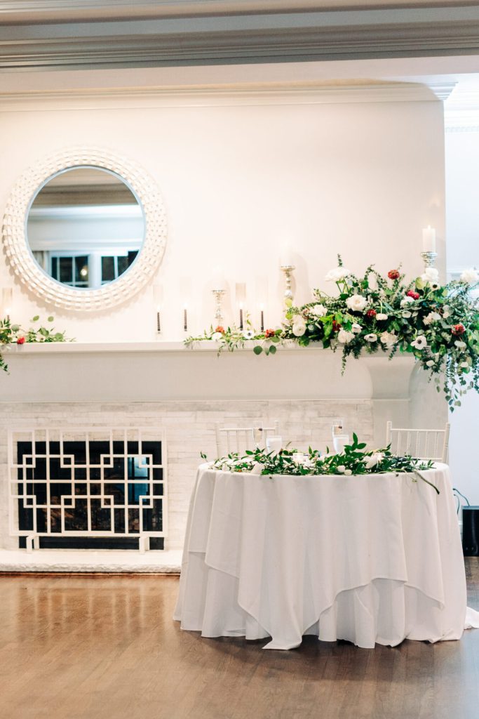 Wedding Reception Decor Green and White Florals on Fireplace