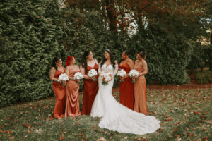 Bride and Bridesmaids Outside at Avenir in fall colored bridesmaid dresses