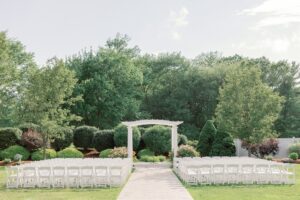 Summer outdoor wedding ceremony at The Villa's pergola.