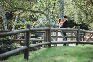 Bride and groom pose on a bridge at War Memorial Park.