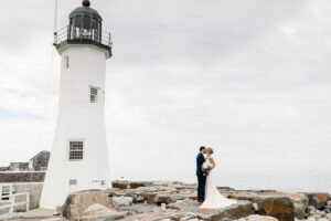Bride and groom posing for wedding photos at Scituate Lighthouse before their celebration at The Lakehouse in Halifax, Massachusetts.