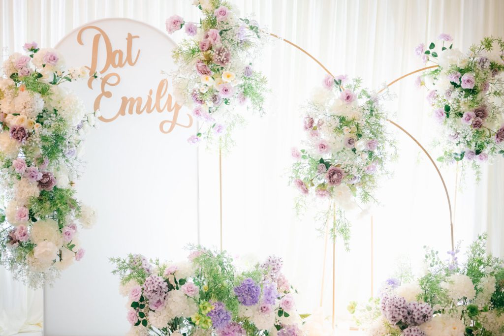 Gold script names on a white backdrop with lavender and blush florals.