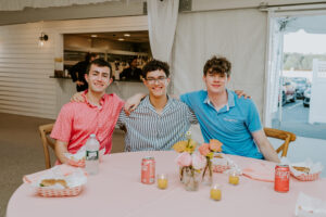 staff arm in arm smiles while eating dinner
