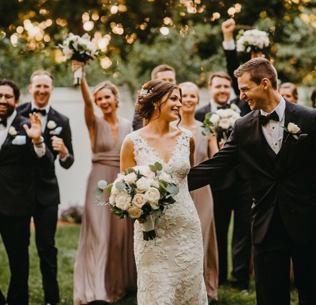 Bride and groom celebrating with their wedding party on the lawn at Saphire Estate.