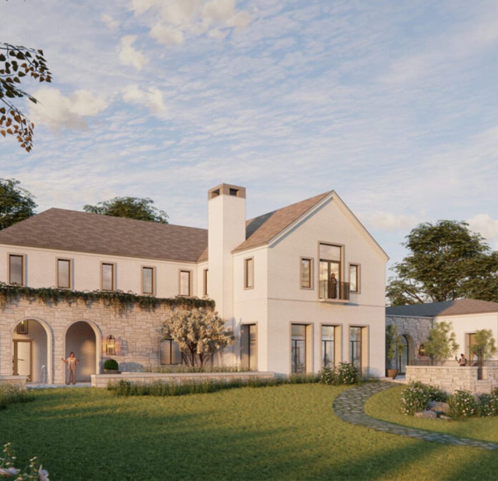 White estate house with arched windows overlooking a lawn at Rosemont.